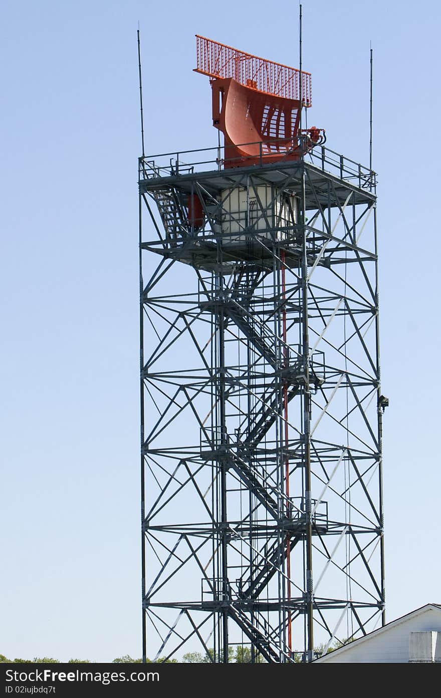 An air traffic controll radar against a blue sky.