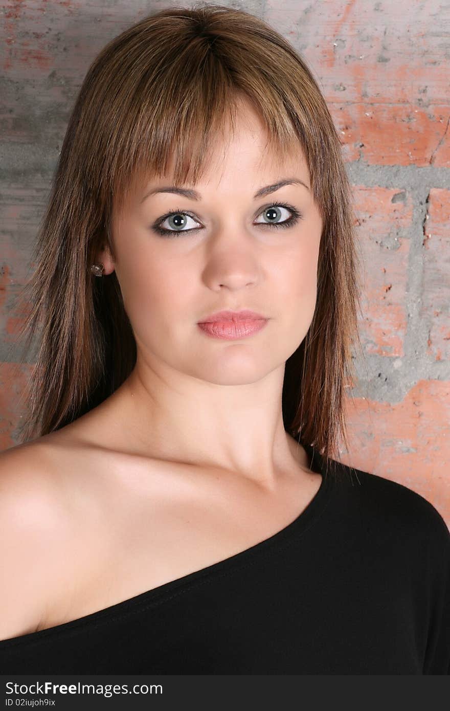 Beautiful young female model against a brick-wall. Beautiful young female model against a brick-wall