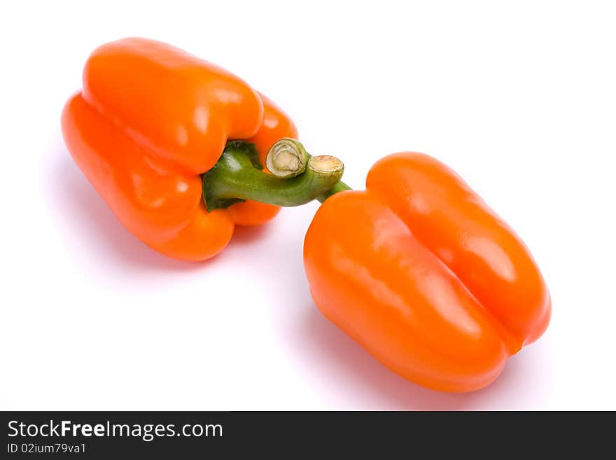 Two orange sweet peppers isolated over white background.