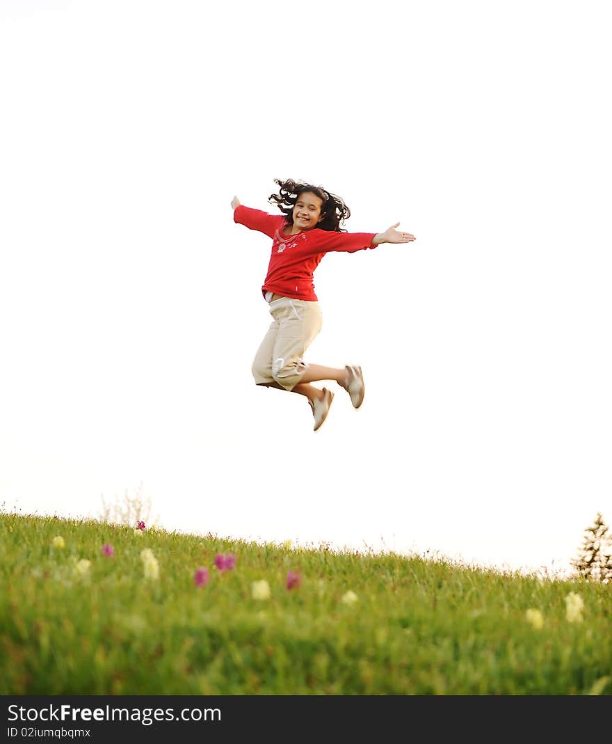 Happy acrobatic girl on meadow