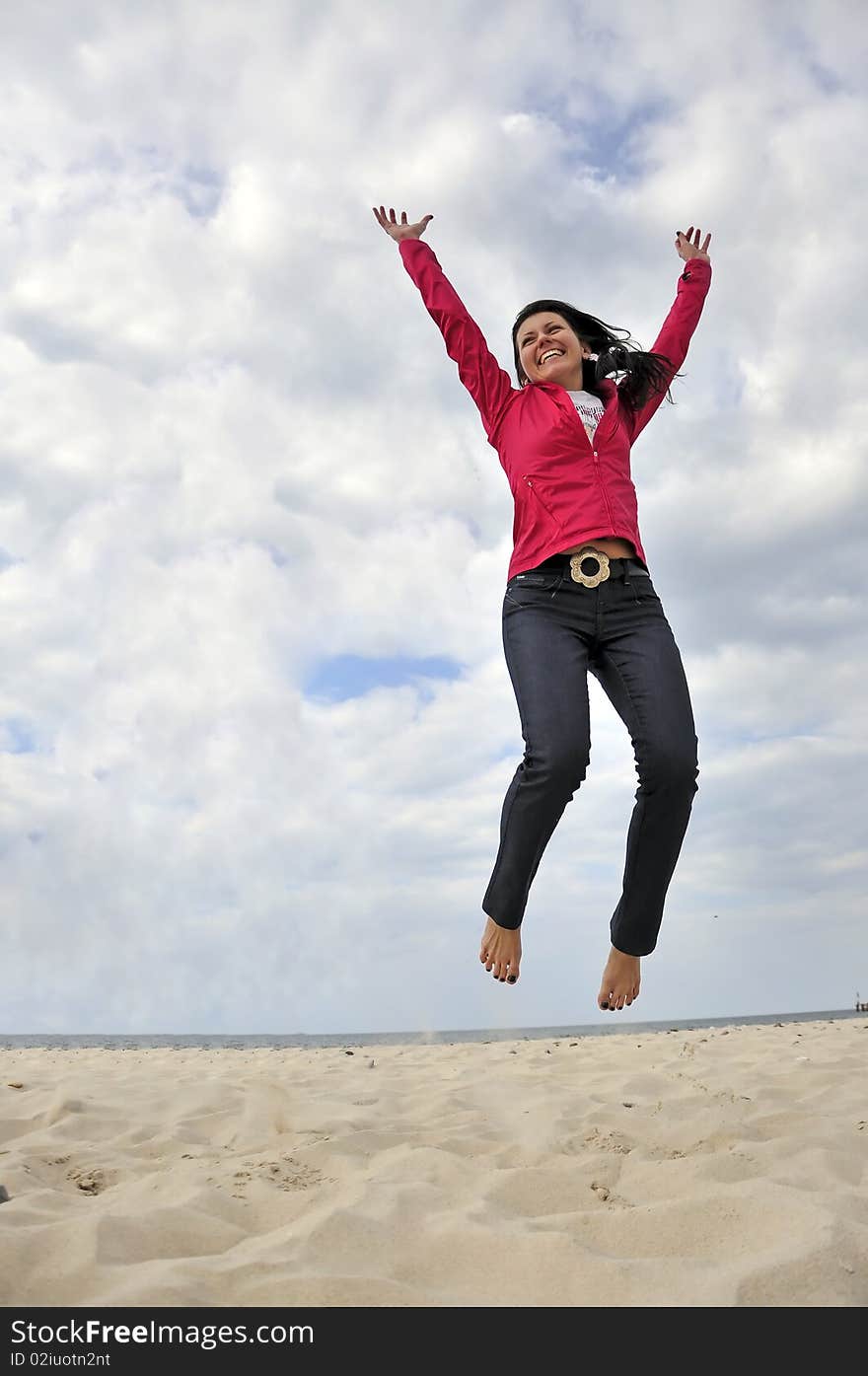 An image showing young girls jumping on the beach. An image showing young girls jumping on the beach