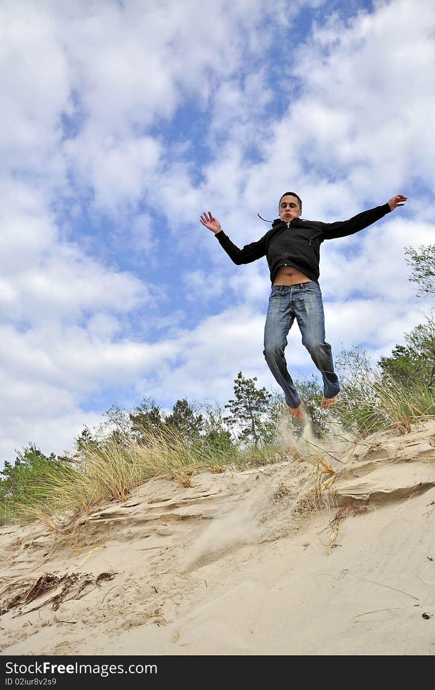 An image showing young boy jumping on the beach. An image showing young boy jumping on the beach