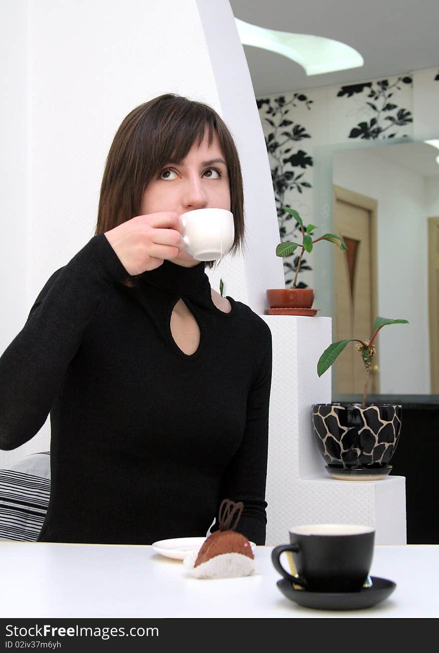 Nice girl drinking coffee in a cafe