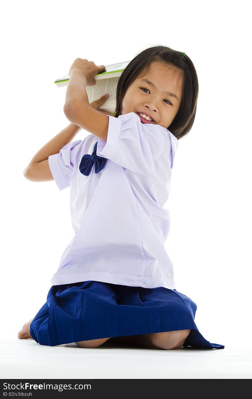 Cute girl throwing a book, isolated on white background