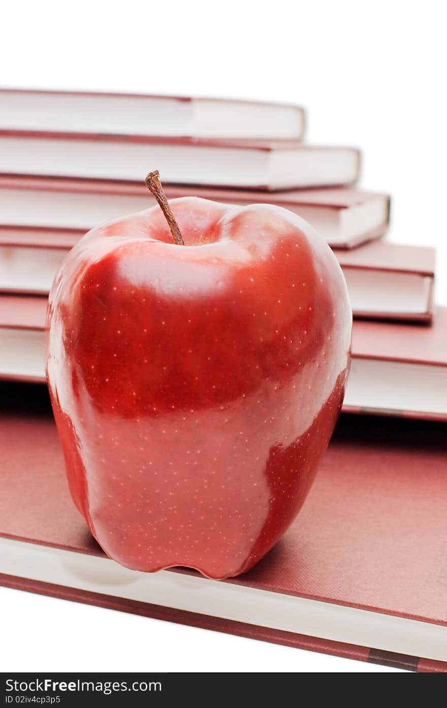 Stack of books and apple isolated