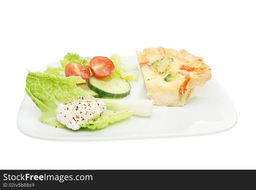 Slice of quiche with a salad on a plate. Slice of quiche with a salad on a plate