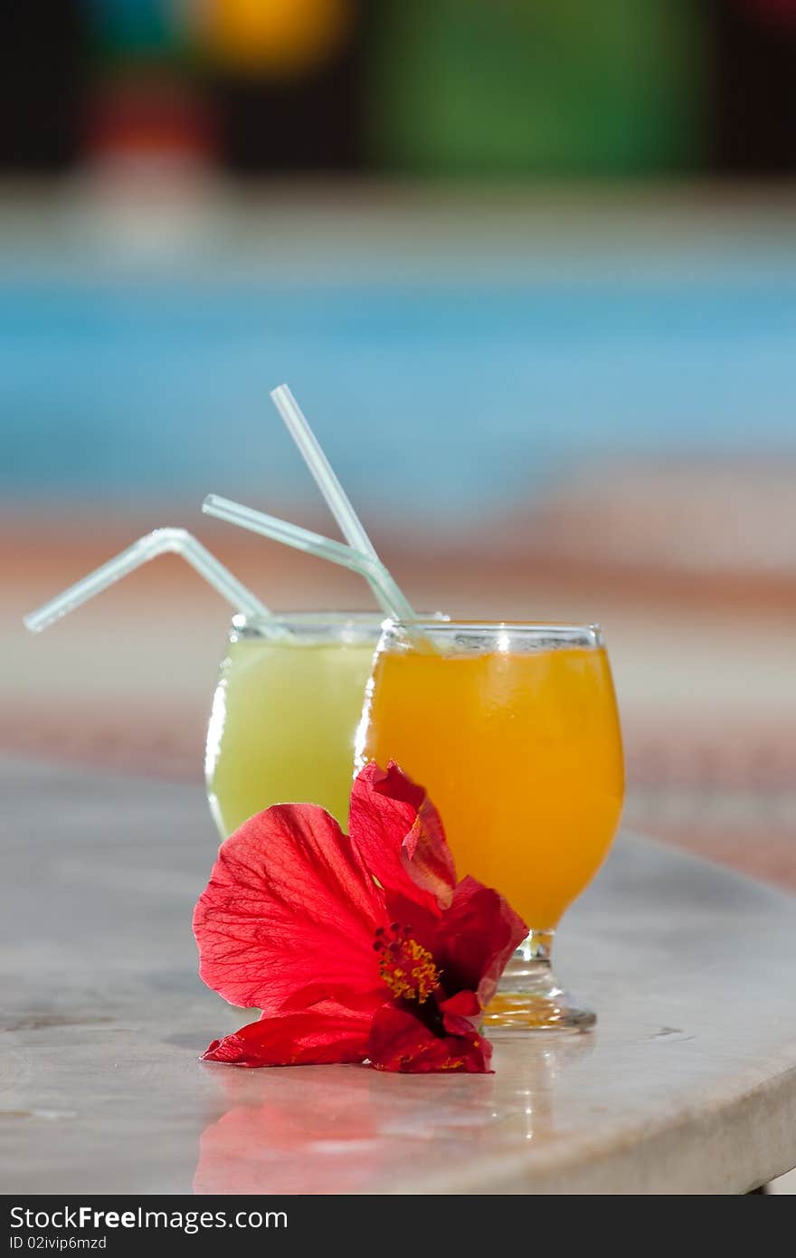 Two tropical cocktails on a table