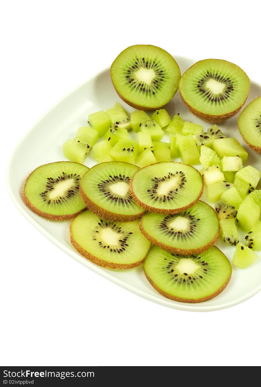 Slices of the kiwi on the white plate. Slices of the kiwi on the white plate