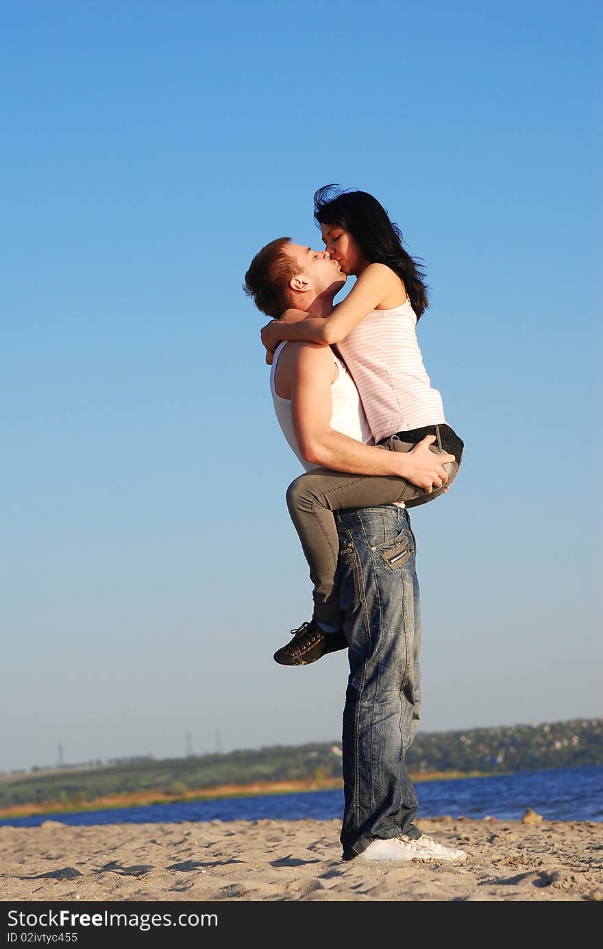 Couple kissing on the beach. Couple kissing on the beach