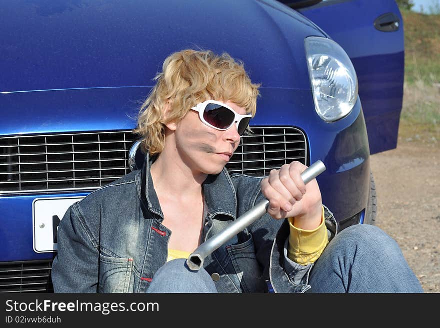 Young woman with spanner tired of repairing a broken motor and sat down beside him, she was wearing sunglasses, denim jacket, a bright yellow blouse and with bands of burning on the face. You can find more pictures from this series here:. Young woman with spanner tired of repairing a broken motor and sat down beside him, she was wearing sunglasses, denim jacket, a bright yellow blouse and with bands of burning on the face. You can find more pictures from this series here: