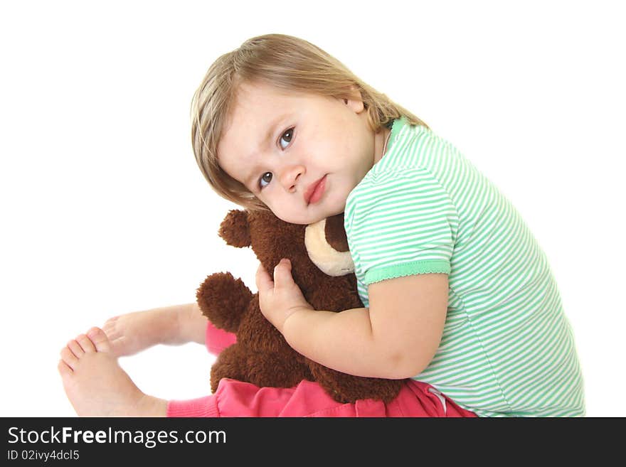 Baby girl holding her teddy bear. Isolated on white background. Baby girl holding her teddy bear. Isolated on white background