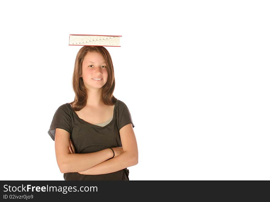 Teen girl balancing a book on her head on an isolated background