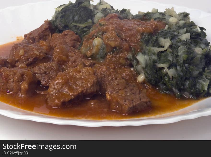 Mangold and stewed beef on plate