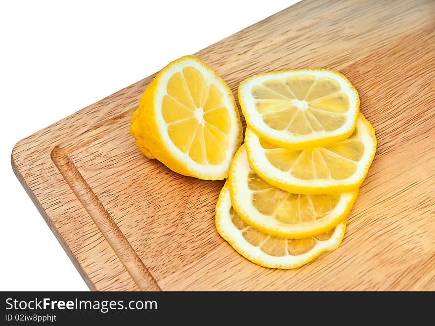 The cut lemon on a kitchen board