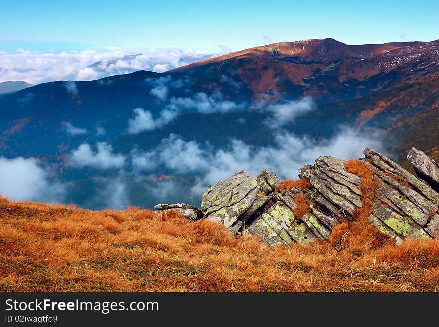 Mountain landscape with foggy clouds. Autumn morning. Mountain landscape with foggy clouds. Autumn morning