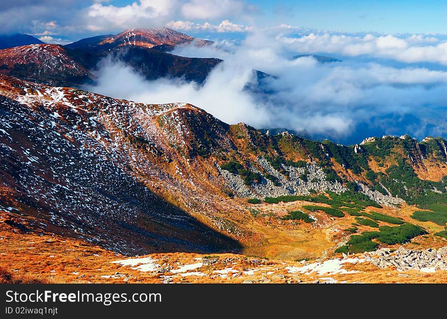 Mountain landscape with foggy clouds. Autumn morning. Mountain landscape with foggy clouds. Autumn morning