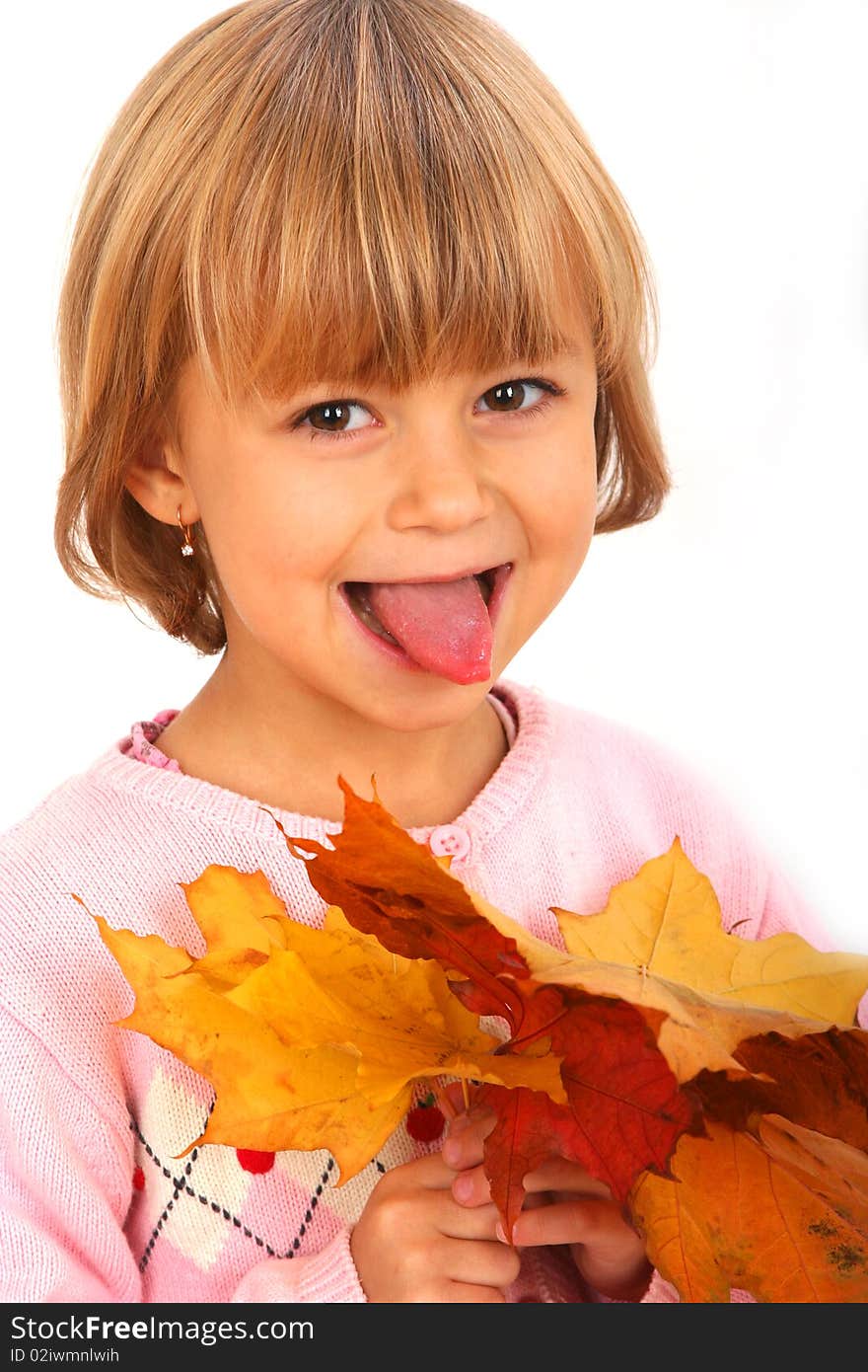 Little showing tongue girl with maple leaves against white background. Little showing tongue girl with maple leaves against white background