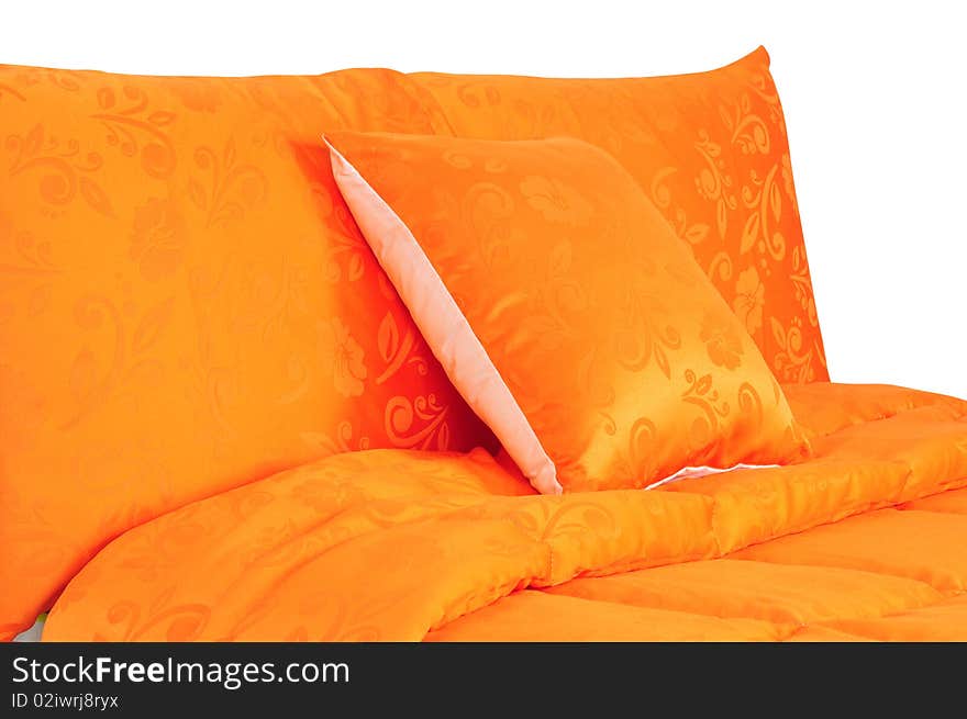 Vibrant orange bed spreads with extra pillow. Vibrant orange bed spreads with extra pillow.