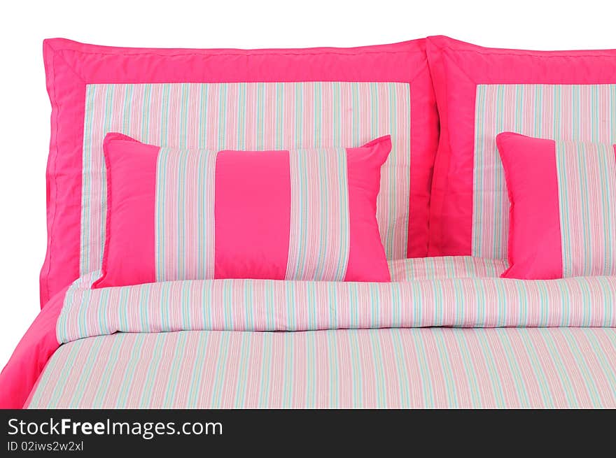 Pink stripped bed spreads over white. Pink stripped bed spreads over white.