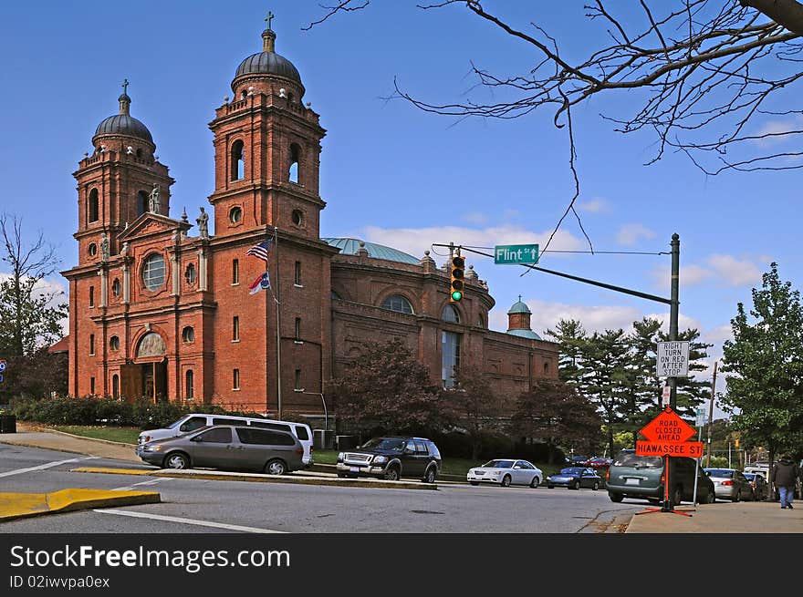 Downtown Ashville with church and traffic in view with clear blue sky above.