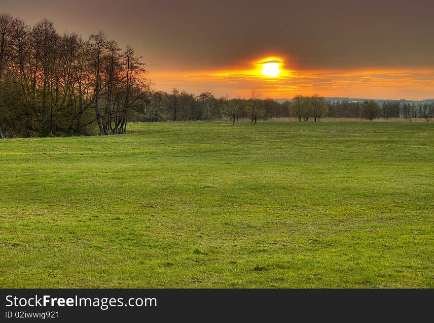 Spring Susnset. Nice colors, green grass, sky overcast