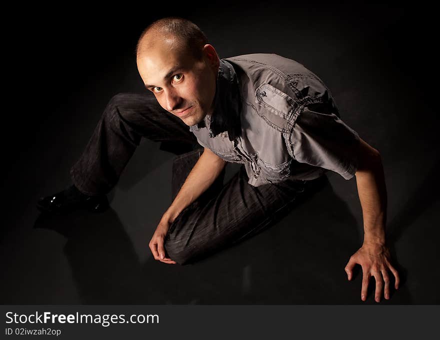 Young man sitting in the dark