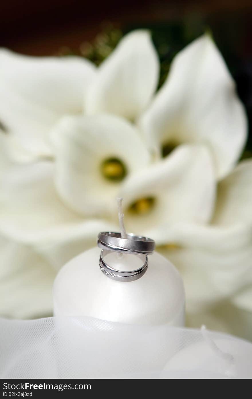 Wedding Rings and white Candle and Flowers. Wedding Rings and white Candle and Flowers