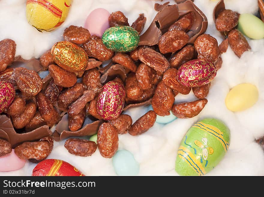 View of several colorful and painted easter eggs and sweet almonds. View of several colorful and painted easter eggs and sweet almonds