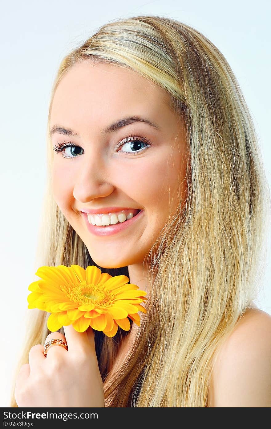 Young woman with a flower. Over white background