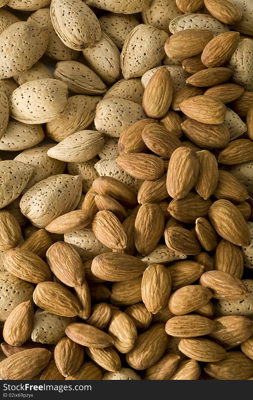 Shelled and  unshelled almonds filling the frame. Shelled and  unshelled almonds filling the frame