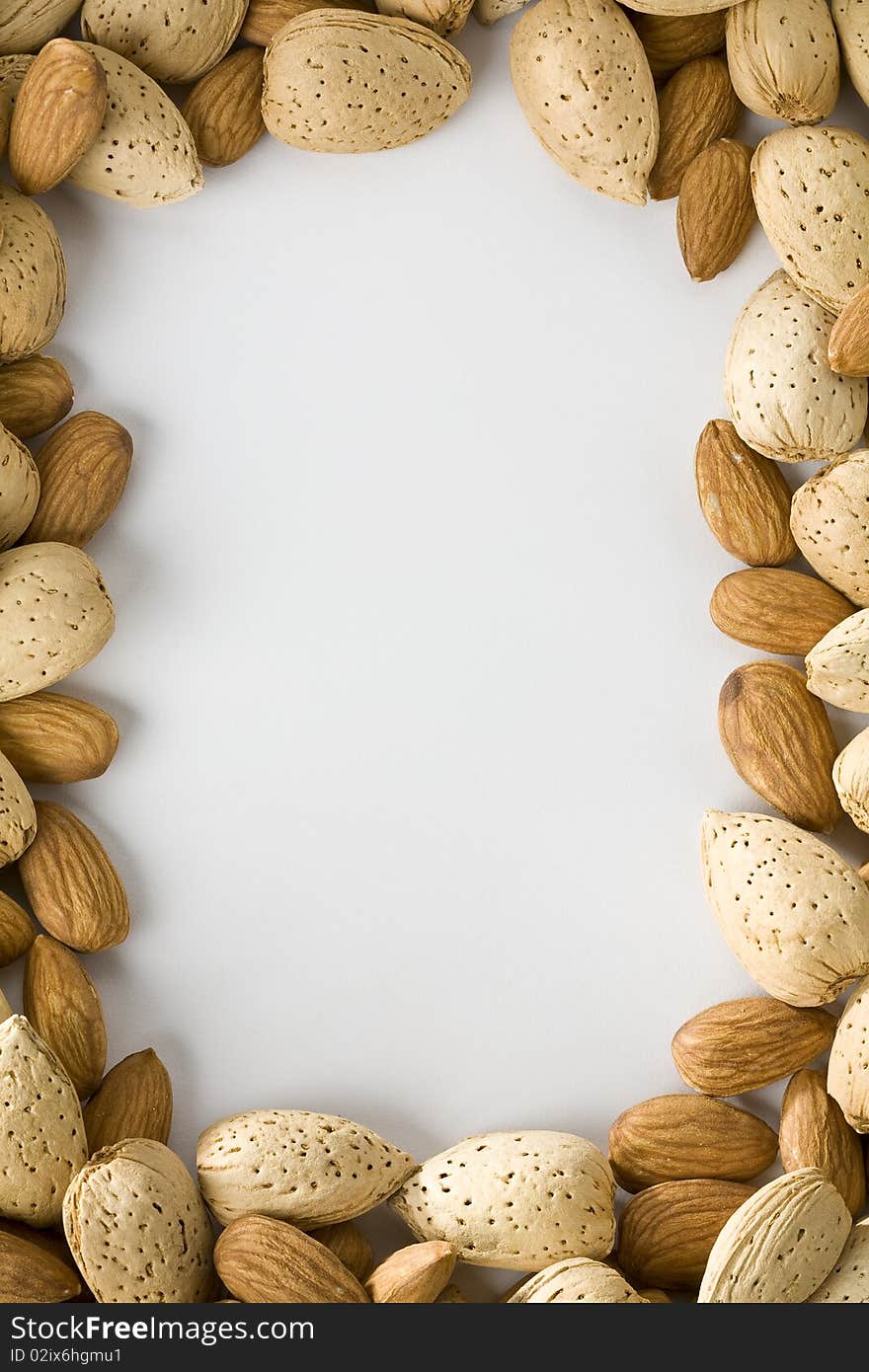 Shelled and unshelled almonds creating a border. Shelled and unshelled almonds creating a border