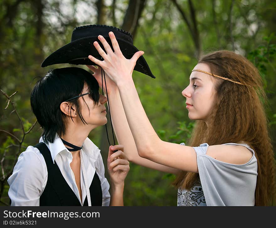 Two girls in the forest - American stylization like cowgirl and Indian