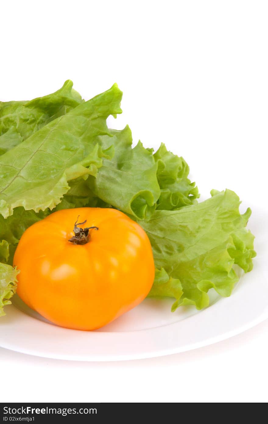 Tomatoe and salad on a plate