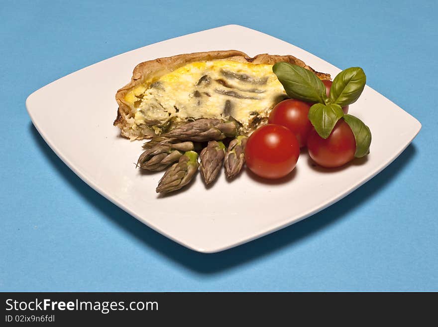 Asparagus omelet served with tomatoes and basil