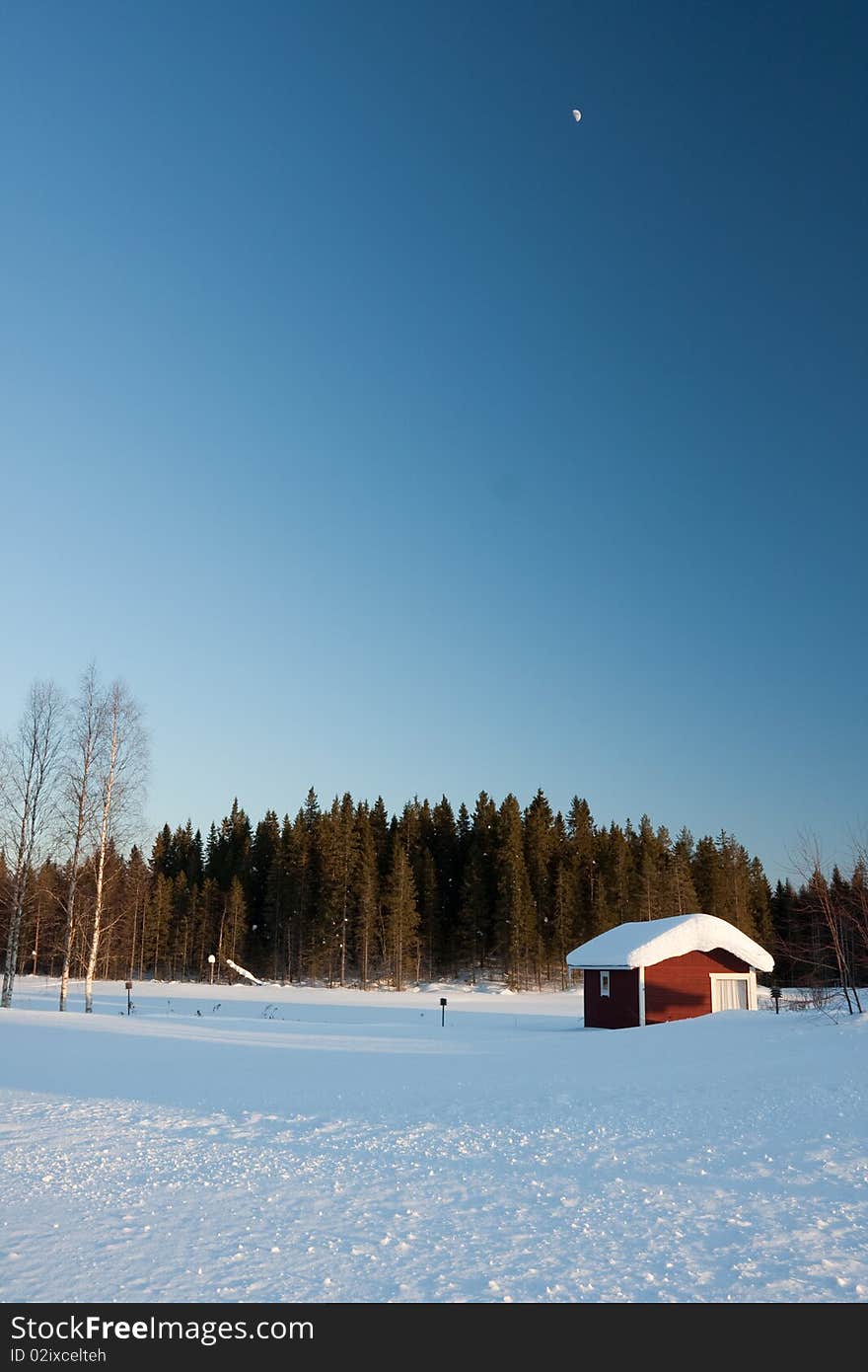 Small wooden house in winter.