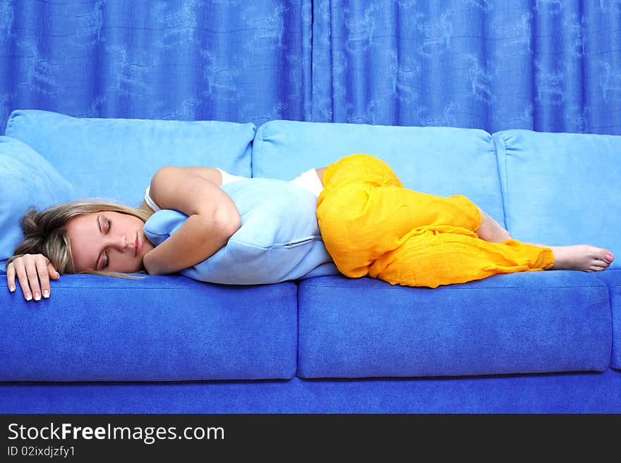 Young woman sleeping on blue sofa