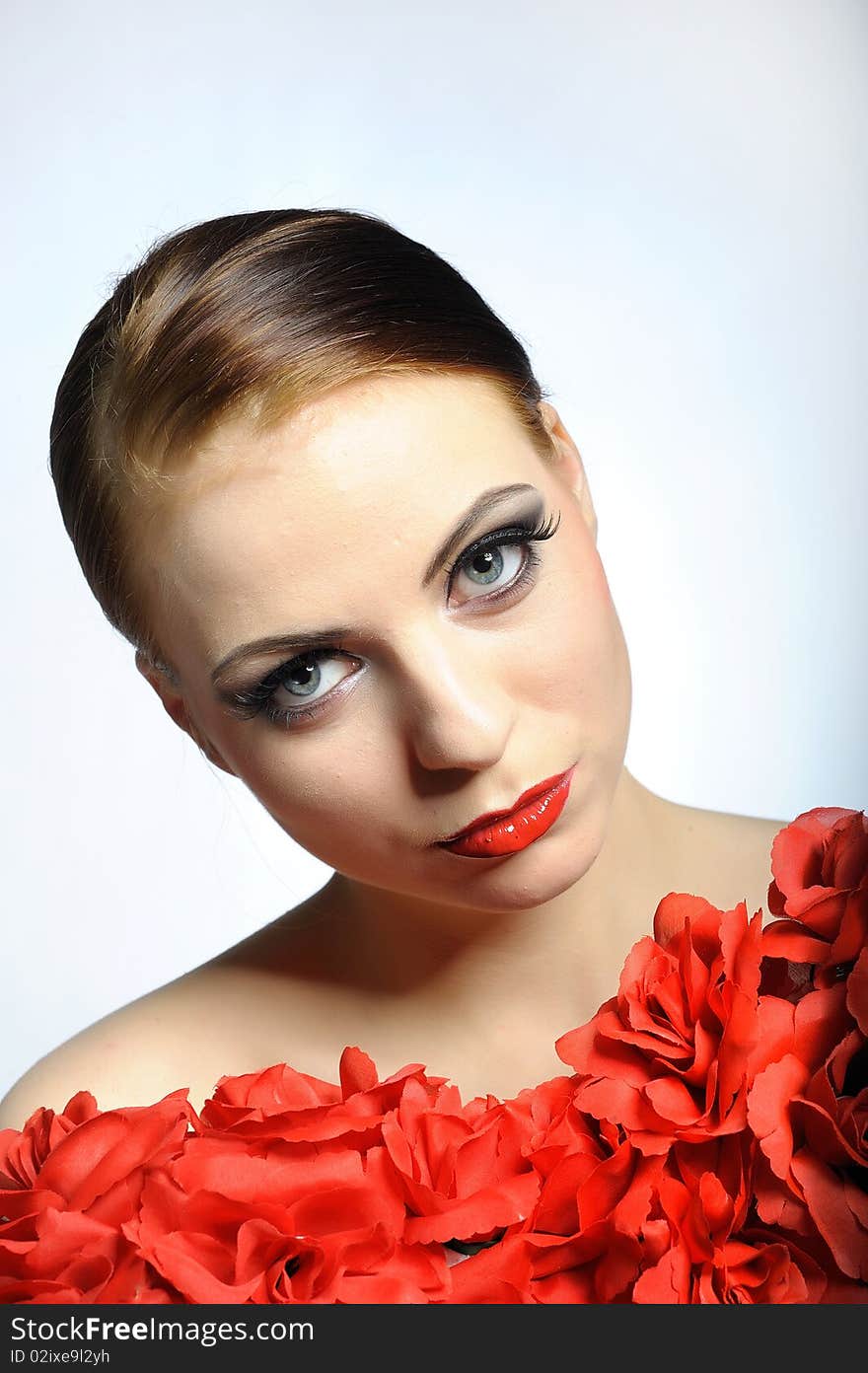 Young elegant aristocratic beauty female face with red shiny lips and black eye makeup. colse-up.