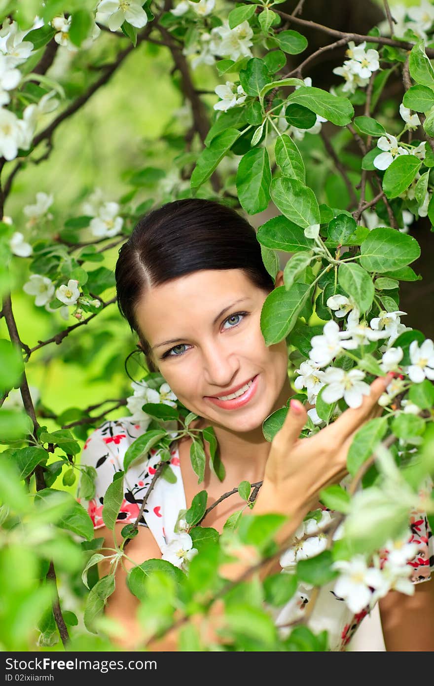 Beautiful smiling woman with flowering tree