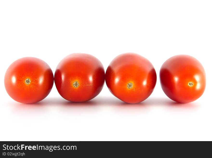 Four tomatoes on a white background