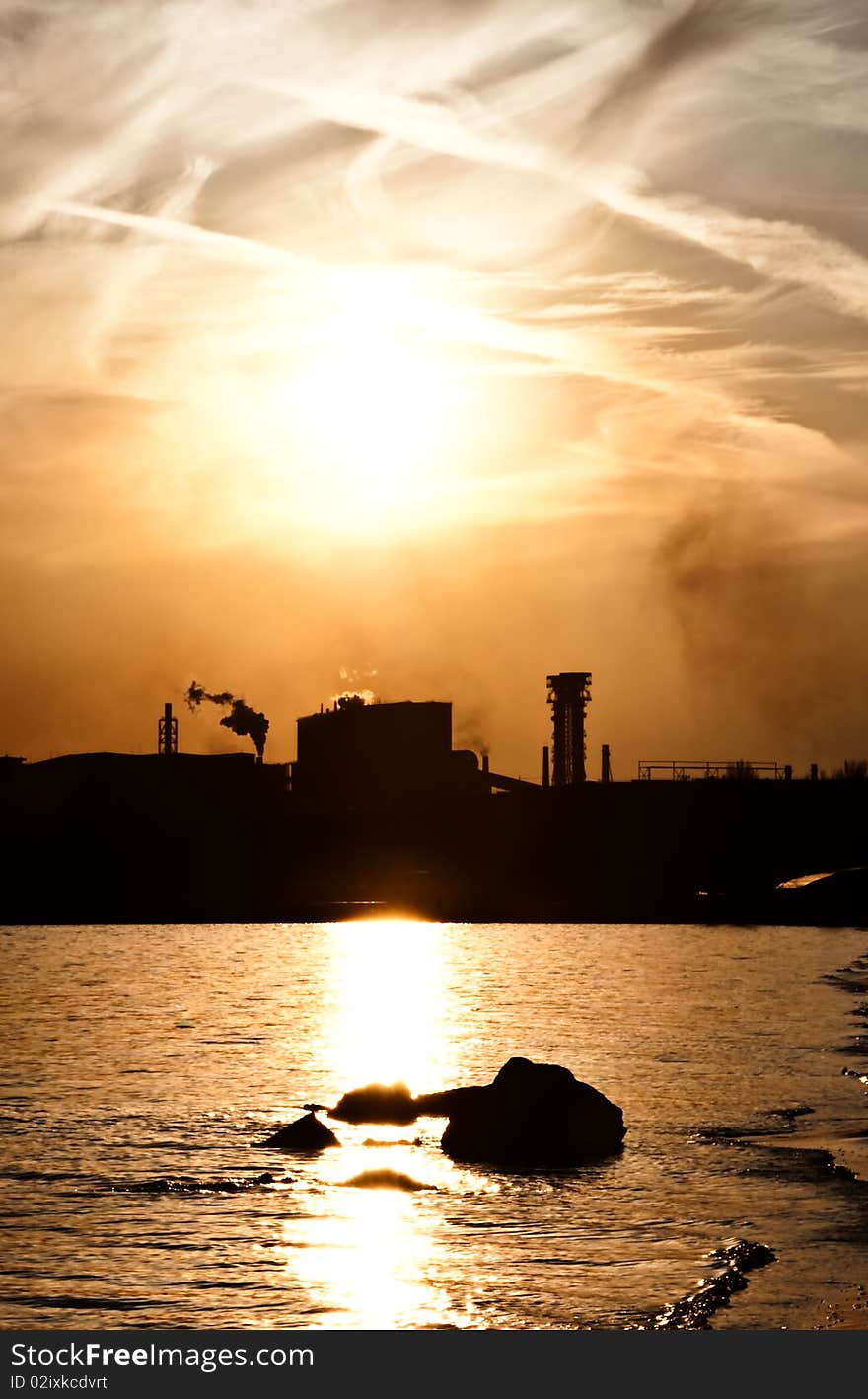 Metallurgical works - pipes and a smoke against the sunset sky. Metallurgical works - pipes and a smoke against the sunset sky