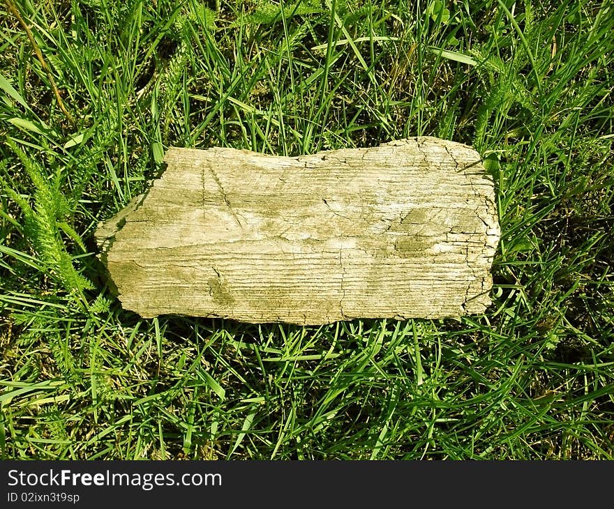 Wooden board on a grass background. Wooden board on a grass background