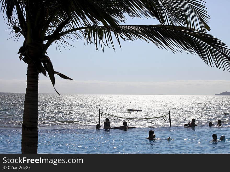 People in a perfect sunny day having fun at the pool. People in a perfect sunny day having fun at the pool