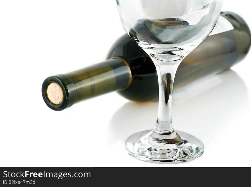 An empty glass on the background of bottles of red wine. An empty glass on the background of bottles of red wine