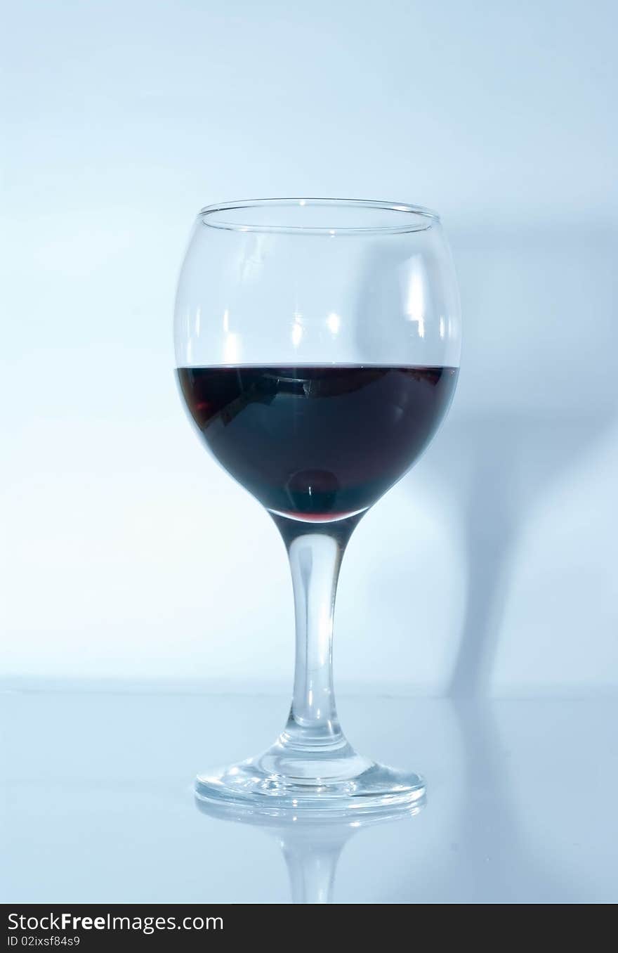 Red wine glass in blue