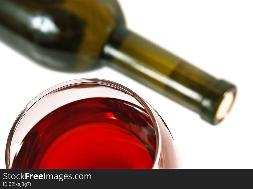 Cabernet sauvignon, focused on the edge of the glass. Bottle on the background. Cabernet sauvignon, focused on the edge of the glass. Bottle on the background