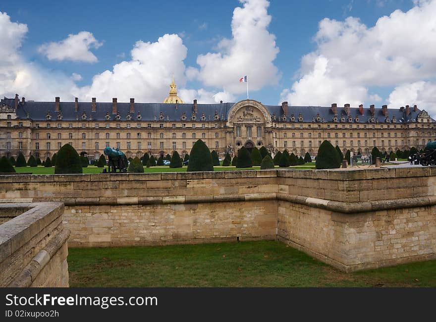 This is the war museum in Paris , it has a park in front  with small  trees and defiance canal. This is the war museum in Paris , it has a park in front  with small  trees and defiance canal