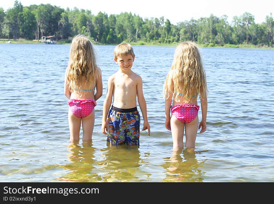 Little Boy With Friends In The Water