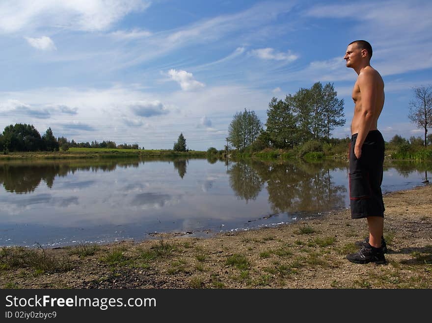 Young man looking at the water surface