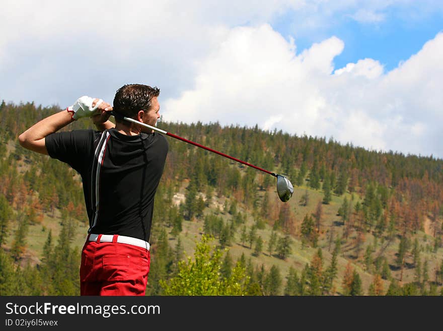 Young golfer in his follow through position with a driver. Young golfer in his follow through position with a driver