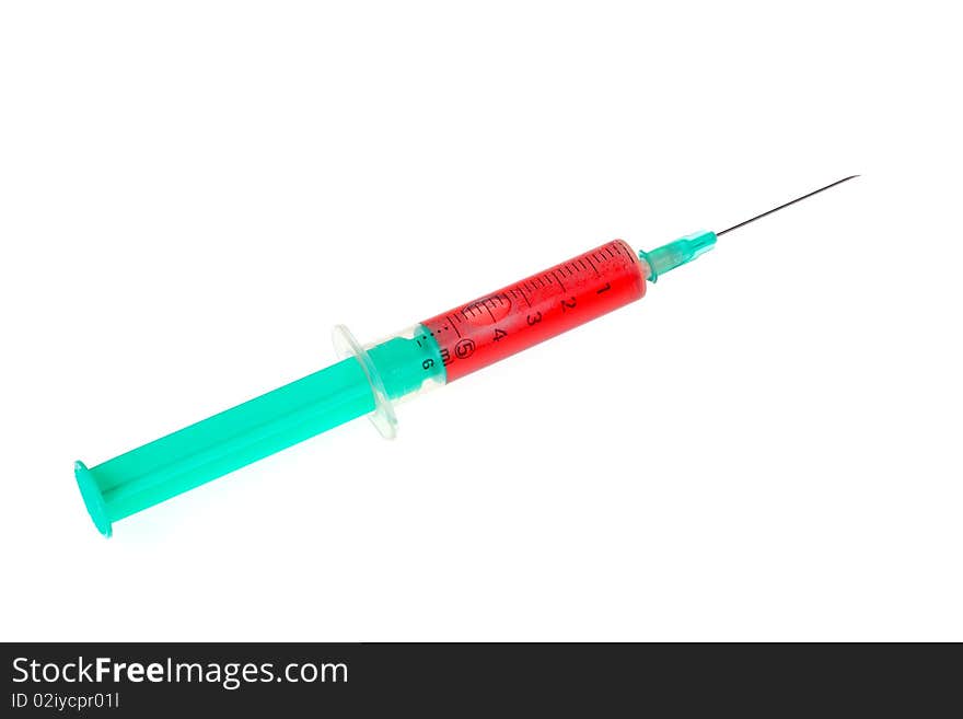 A green syringe with red liquid isolated against white background